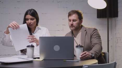 man and woman having a business meeting sitting at desk in boardroom 1