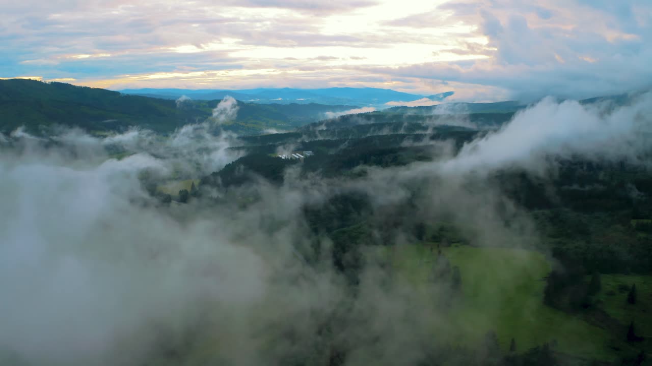 Moving clouds over beautiful european landscape, aerial view before sunset