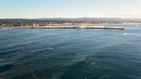 Aerial-view-of-Santa-Cruz-Boardwalk-and-Beach-California-with-surfers-shot-in-4k-high-resolution