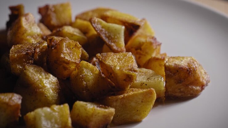 Close-up View of Roasted Potatoes Presented on a Plate - Truck Shot