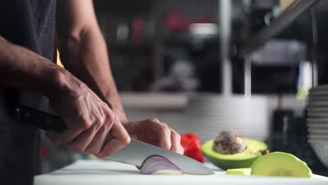 slow motion close up view of a chef slicing red onions under cinematic and beautiful atmosphere