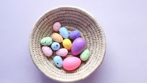 colorful easter eggs in a woven basket