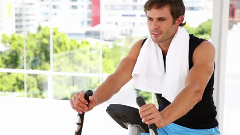 fit man working out on exercise bike