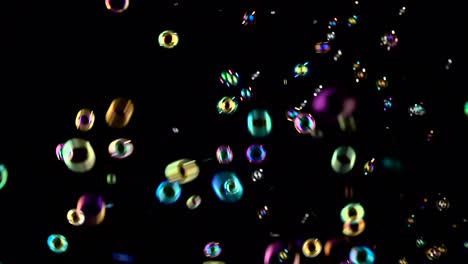 soap Bubbles Start Flying from the Center and Burst Black Backrounds many Small Soap Bubbles Start Flying from the Center and Paw in the Air Black Background