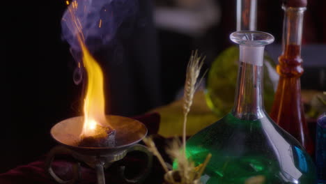 wiccan alchemist: woman igniting a candle  enigmatic smoke