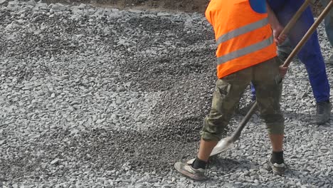 workers with shovel at construction works