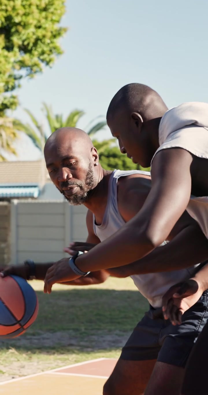 Two Men Playing Basketball on an Outdoor Court