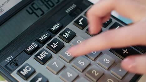 mujer usando calculadora, contabilidad comercial y cálculo de ganancias monetarias