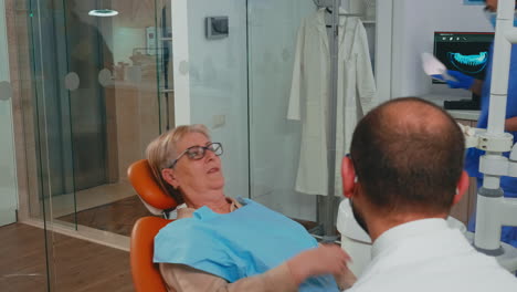 woman with new dental implants looking in the mirror