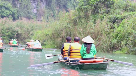 people rowing boats on a scenic river