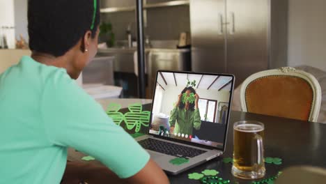 Smiling-african-american-woman-wearing-clover-shape-items-on-video-call-on-laptop