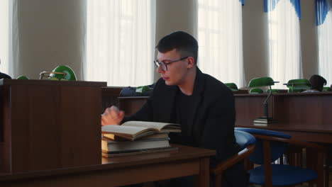 young man reading in a library