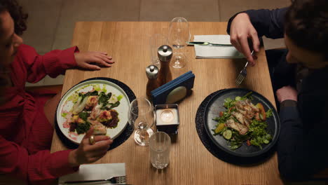 Two-people-enjoy-dinner-in-loft-restaurant.-Couple-celebrate-anniversary-in-cafe