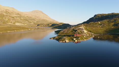 fisherhut in norway near gaustatoppen lake drone shot