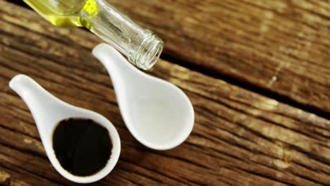 Olive-oil-being-poured-into-appetizer-spoon