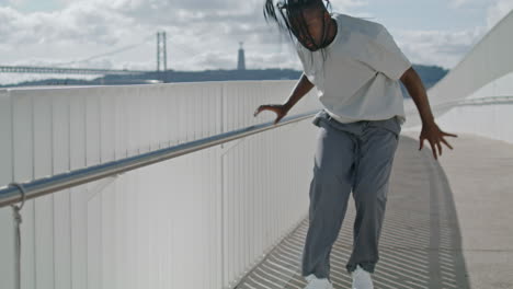 Charismatic-dancer-looking-camera-sea-background.-Dreadlocks-man-choreography