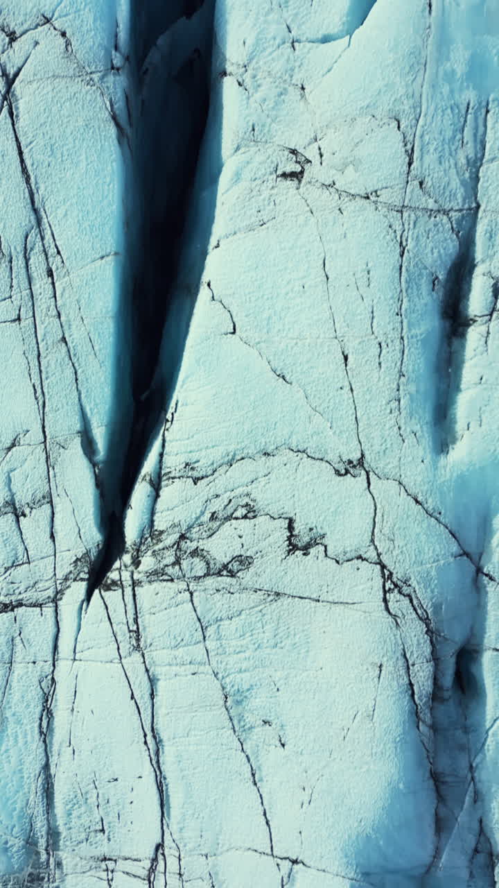 Vertical video: Drone shot of ice caves in iceland