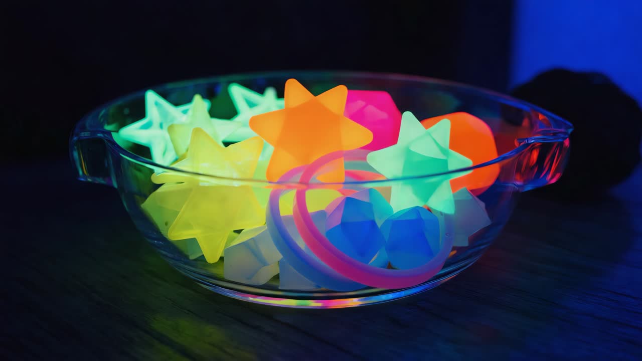 A bowl filled with colorful glowing party favors