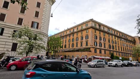 traffic and pedestrians near a historic building