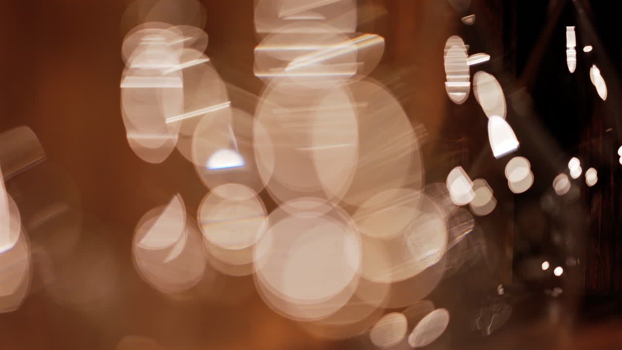 Abstract composition of light trails and overlapping bokeh in warm golden tones