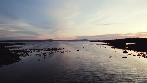 Beautiful-aerial-flying-over-gigantic-irish-lough-corrib-with-many-small-island-silhouettes-in-the-water