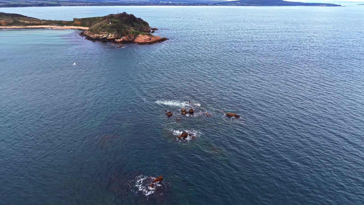 Scenic aerial view of rocky coastline and calm ocean waters