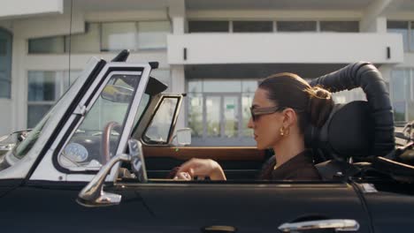 woman applying makeup in a classic convertible car