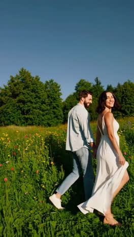 couple walking hand-in-hand through a flower field