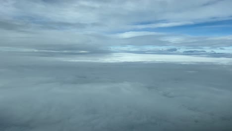 Flying-across-a-cold-winter-sky-shot-from-an-airplane-cabin