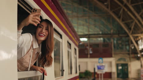 woman taking a selfie on a train