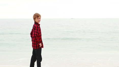 cute boy pointing at the sea