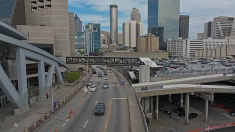 aerial view of traffic on road in atlanta city with skyscraper buildings in background