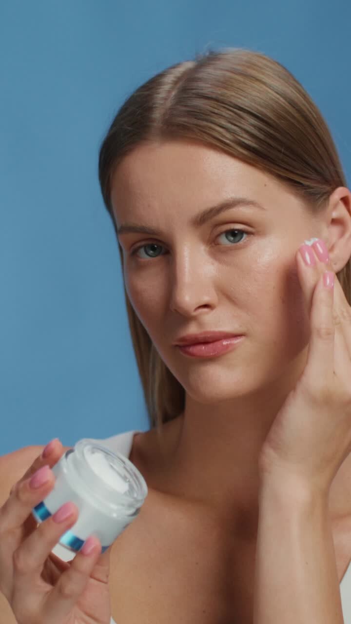 Woman applying face cream