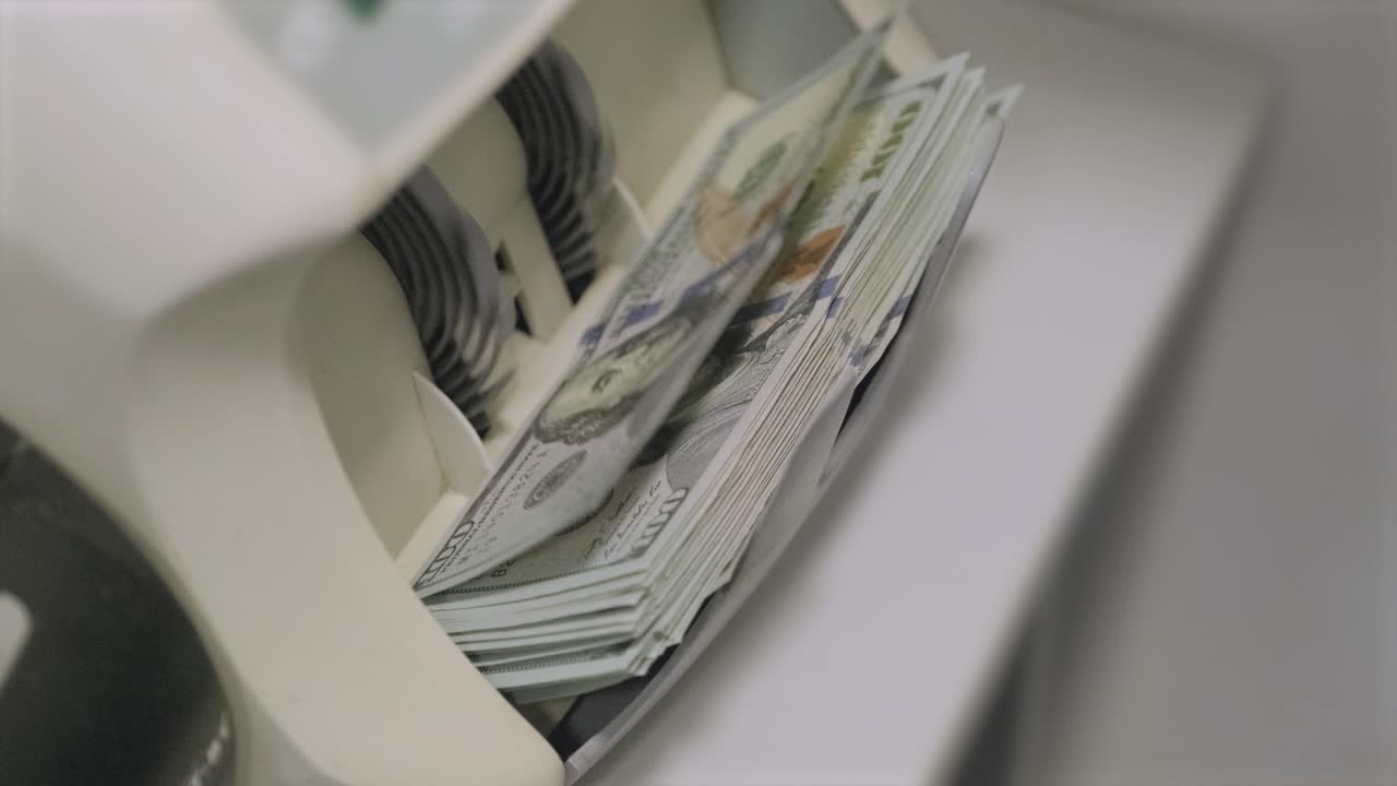 La macchina contabanote conta banconote da dollaro. Mille dollari. Cento dollari.