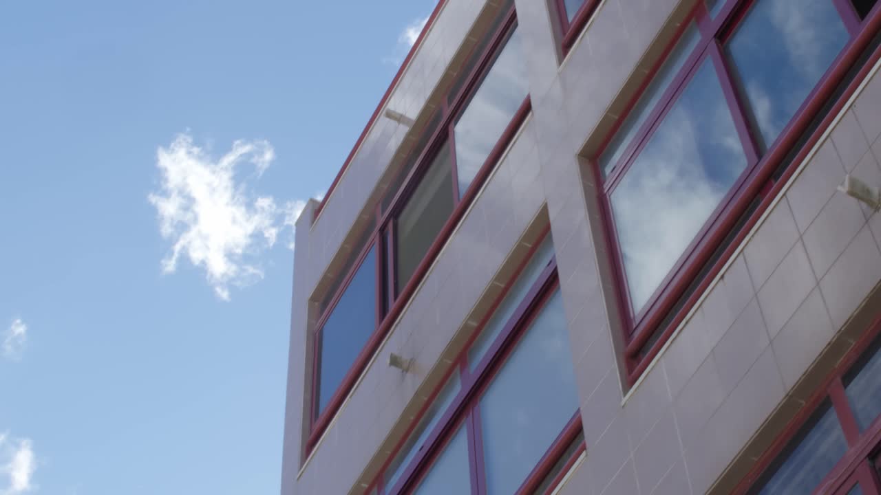 Footage of a building with sky-reflexion in the windows.