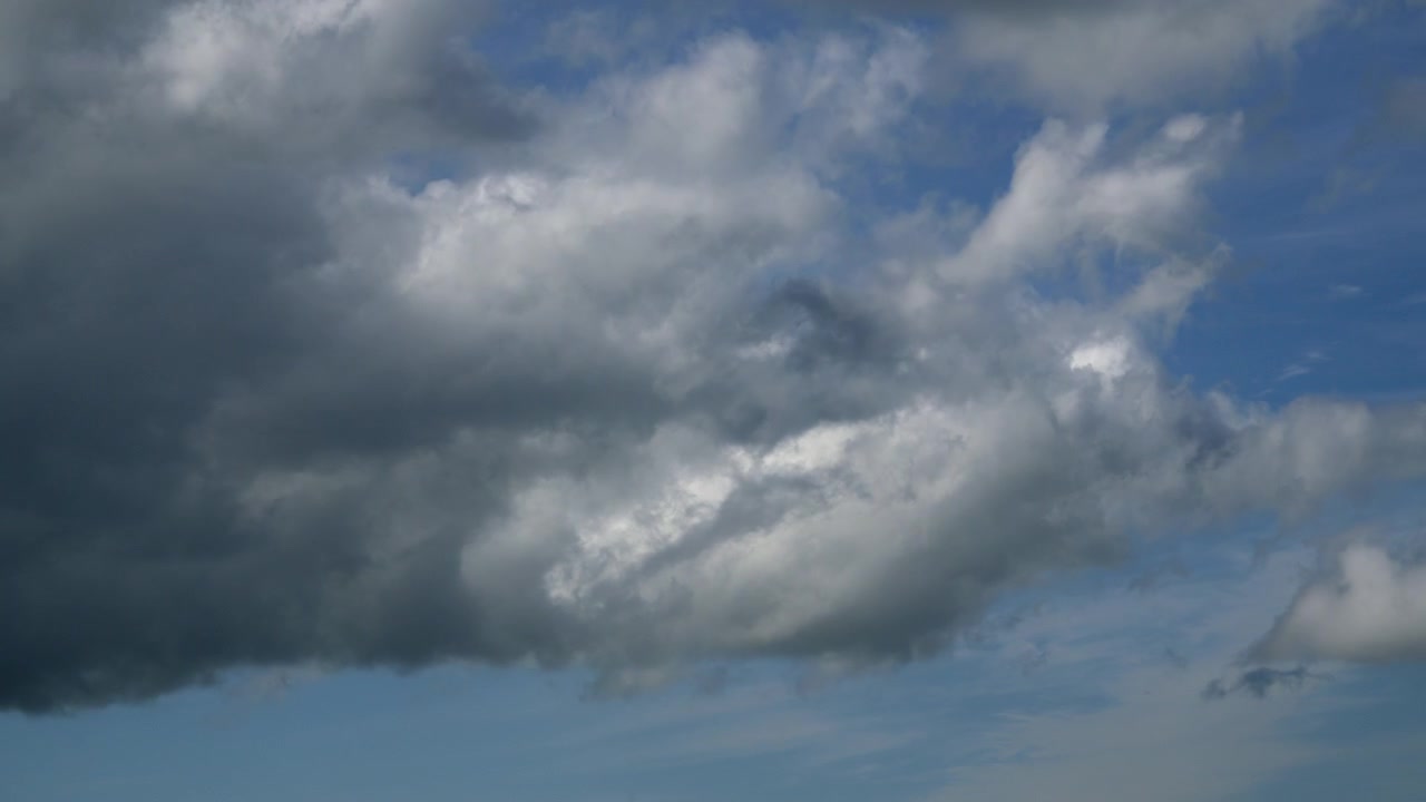 Clouds Gathering And Darkening Against Blue Sky. Timelapse 30x.