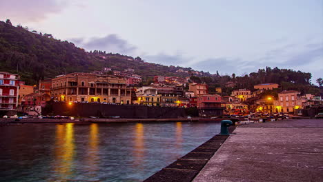 catania, italy: view of the port along the beach town of the metropolitan city of catania, italy on a cloudy day in evening timelapse