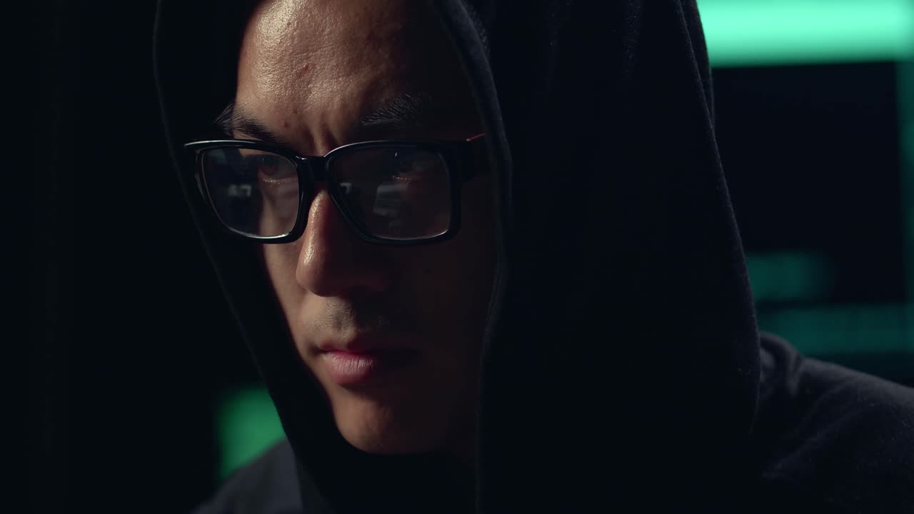 Close Up Asian Male Hacker Using Computer Hacking