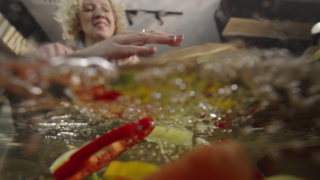 Woman preparing vegetables in water