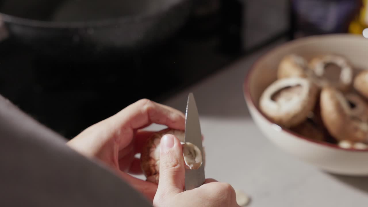 Close Up Of Woman's Hands Cutting And Cleaning Mushrooms In The Kitchen