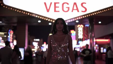 a captivating woman in sparkling attire strides confidently through a vibrant, neon-lit street scene, signaling the exciting energy of nightlife.