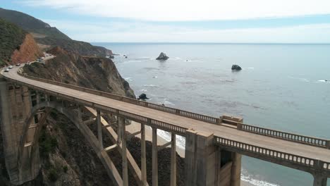 Luftbrummen-Stockvideo-Von-Bixby-Bridge-Highway-Mit-Wasser-Und-Ufer-Unten-In-Big-Sur-Monterrey-Kalifornien