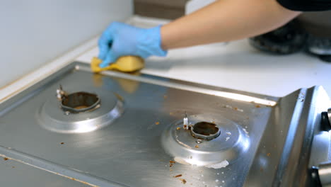 mopping commercial kitchen. kitchen staff member wipes down a stainless steel surface, ensuring cleanliness during busy lunch hours