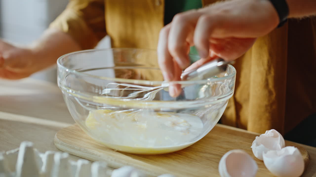 Hands pouring milk omelette dough preparing food standing modern kitchen closeup