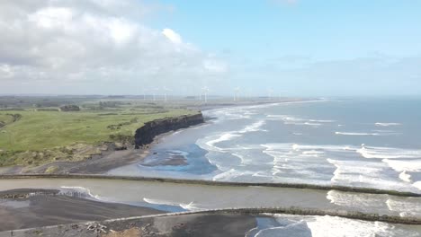 aerial panoramic of waipipi wind farm on new zealand coastline, scenic seascape