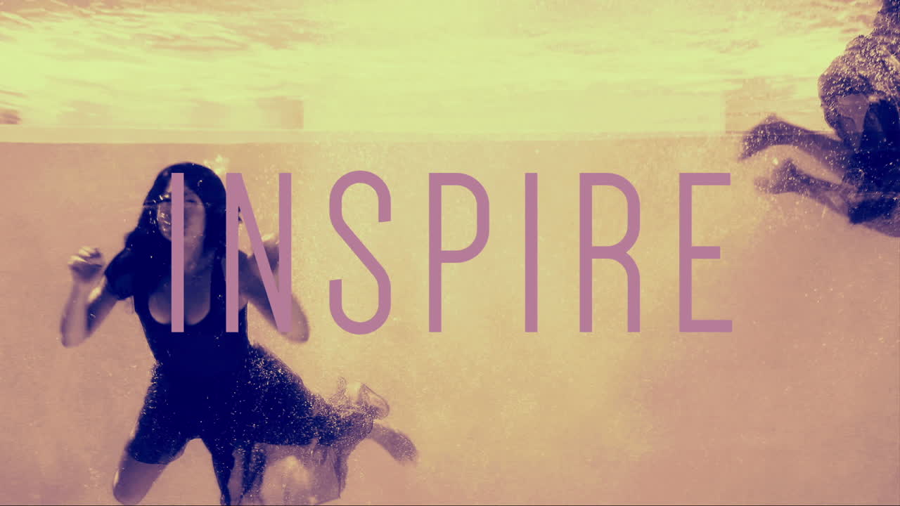 Women in evening gowns diving into pool with inspire text