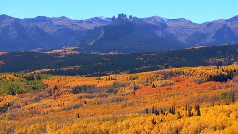 crested butteohio kebler swampy pass fall autumn auburn peak colors castle mountain aerial drone colorado vibrant thick full aspen trees gunnison national forest morning sunny blue sky backwards