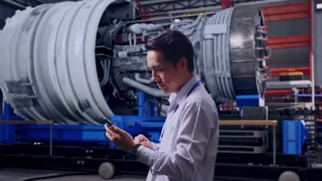 engineer inspecting jet engine in factory