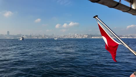istanbul skyline with turkish flag waving in slow motion