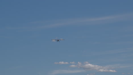 small propeller airplane flying in the blue sky